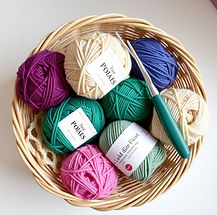 balls of yarn in a basket with a crochet hook.jpg