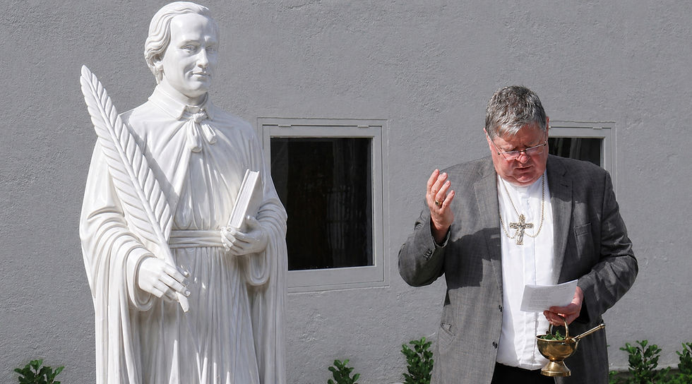 Bishop Richard Lawrenson blesses a new marble statue of Saint Peter Chanel on his feast day in Hamilton.