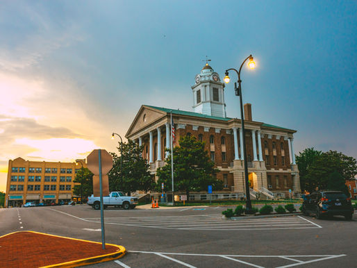 The historic Bedford County Courthouse stands at the center of Shelbyville beneath dramatic clouds.