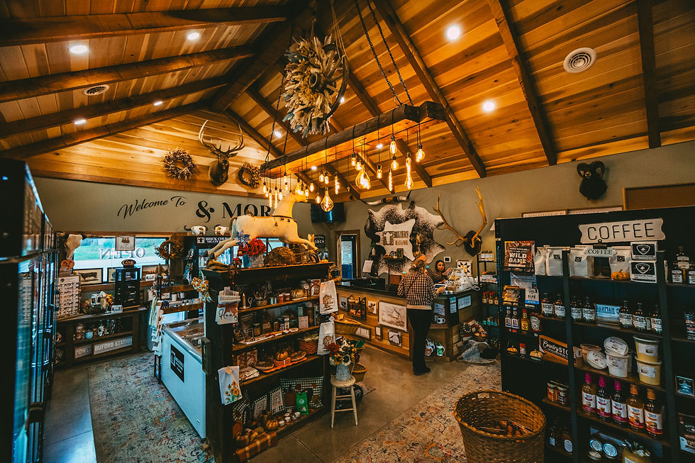Inside Brick Church Meats & More, showing a rustic market with wood ceilings, hanging lights, and shelves stocked with coffee and local goods.