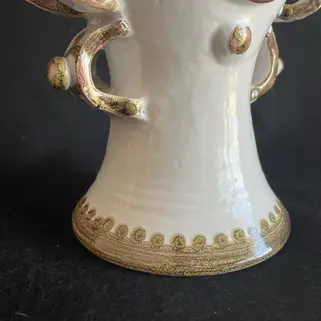 Close-up of the Costanza Sicilian ceramic sculpture showing the glazed surface, sculpted details and handcrafted gold and bro