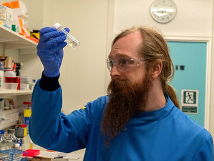Callum Highmore looking at liquid in a test tube