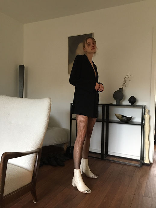 Model wearing Rich Cast of Characters Margot boots in Ivory Cream Leather.