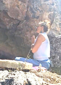 Prayer hands at rock with drum