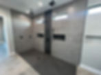 Modern master bathroom shower with dual heads & grey tiles