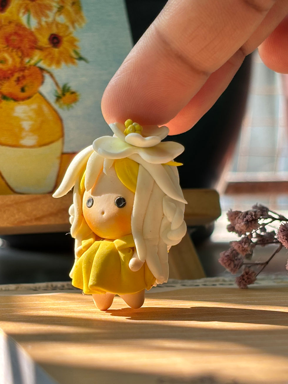 Thumbnail: solara solar fairy keychain handmade clay pixie with golden hair and white flower crown - Angle view