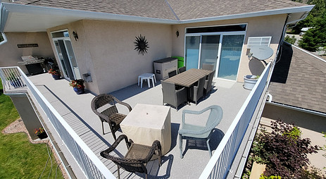 a beautiful balcony with table and chairs under the sun.