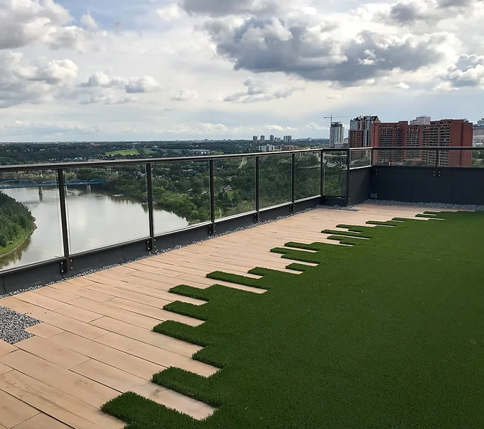 A Tanzite stonedeck outdoor space in White Oak color overlooking a very nice view of a river.