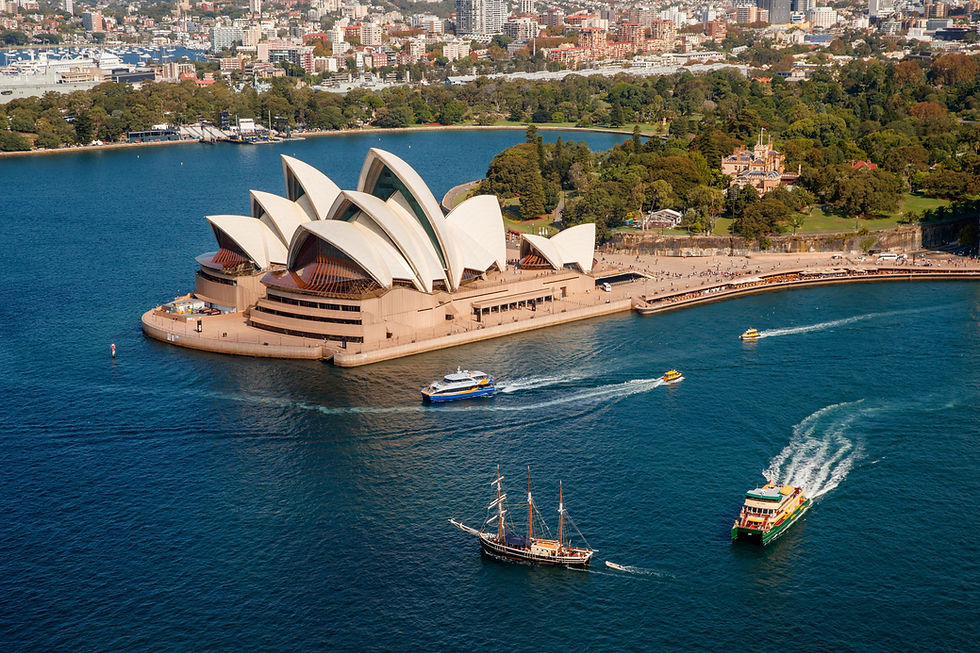 Ferries and tallship on Sydney Harbour passing the Sydney Opera House Destination NSW