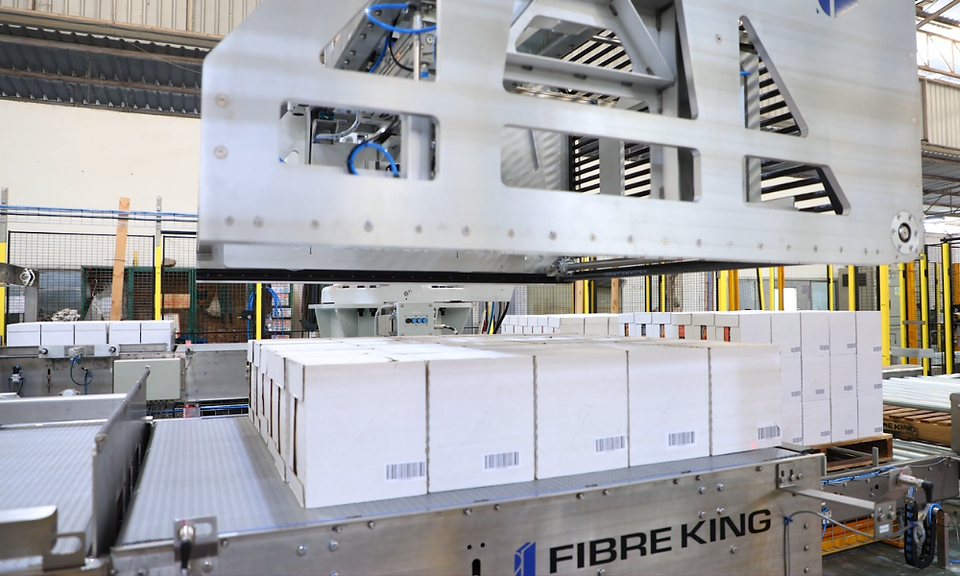 Fibre King non-vacuum robotic gripper collecting a complete layer of shelf-ready cases.