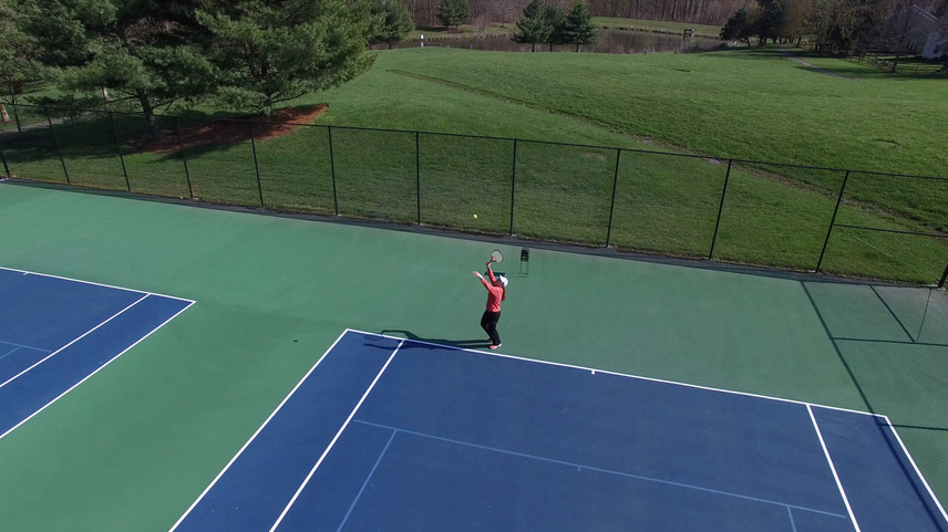 tennis serve w lake.jpeg