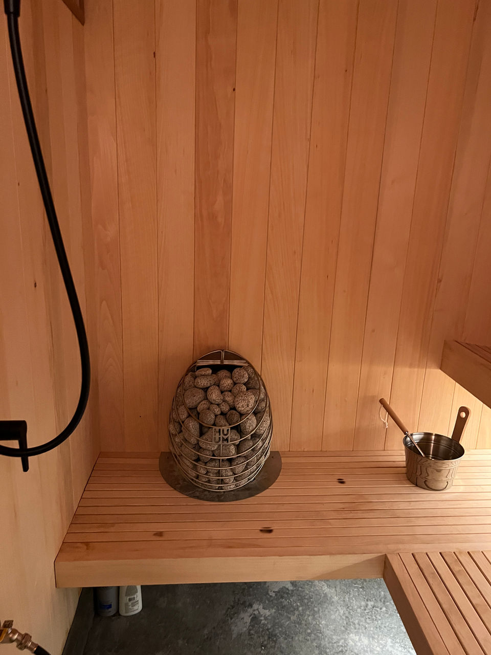 Hum Drop Electric Sauna Heater in a sauna built with Clear Western Red Cedar material for a clean and modern look.