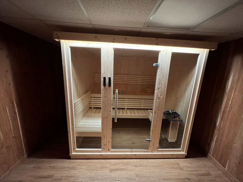 Custom Indoor Sauna Kit with a Glass Door and Two Floor to Ceiling Glass Windows.