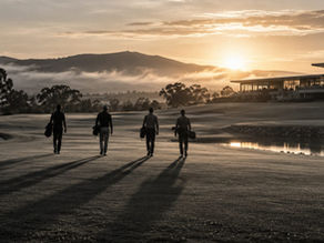 Four golfers walking toward a clubhouse at dawn, representing athletes moving from contractual rights to ownership risk.
