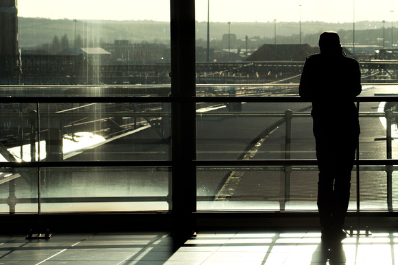 A photo of a man waiting in Leeds Train Station