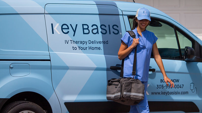 A Key Basis IV nurse with an IV kit beside a Key Basis IV van