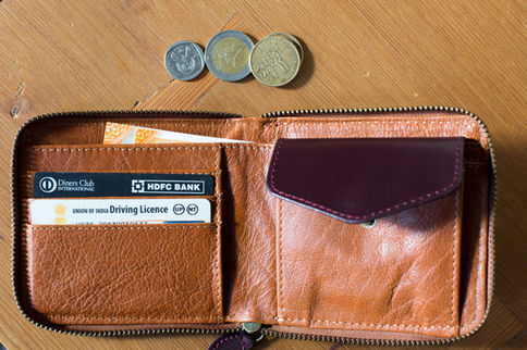 TICH zippered leather wallet open showing card slots and coin pocket