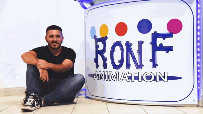 Uomo seduto davanti a RONF ANIMATION logo, Ronf animation, sorridente