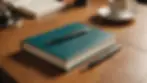 Close-up view of a journal and pen on a wooden table