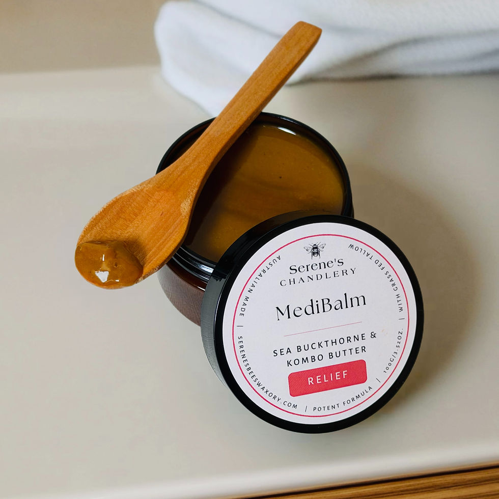 A jar of body oil on a bathroom bench, with a wooden spoon displaying the product.