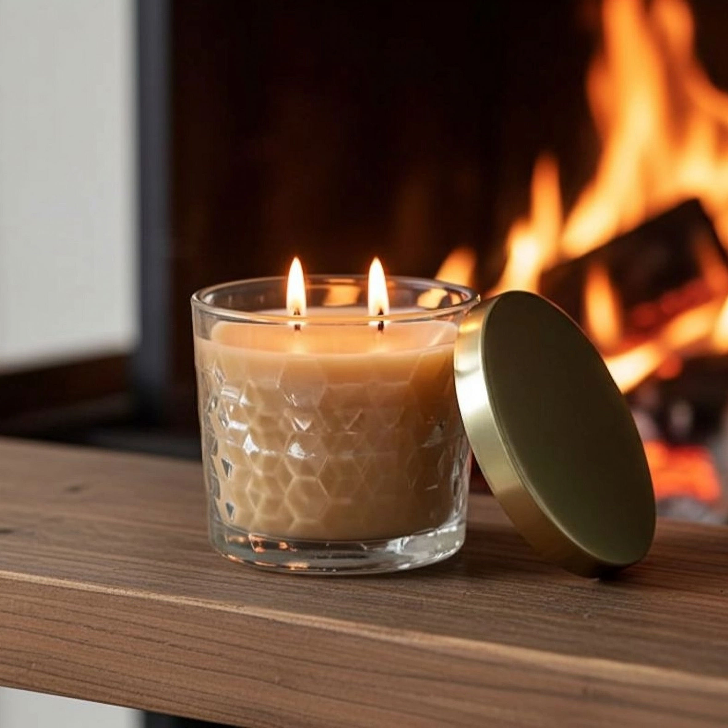 Glass jar candle with lid off.