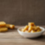 Pure beeswax hexagon pellets in a bowl.