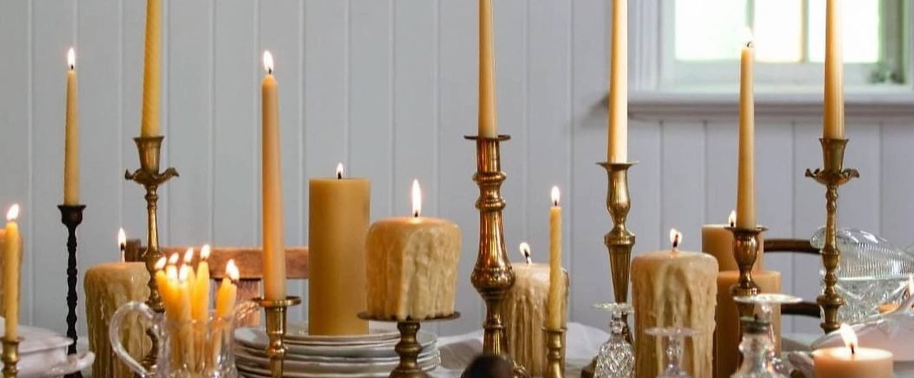 A tabel set with lit beeswax candles