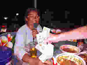 A Thai woman singing karaoke for tips