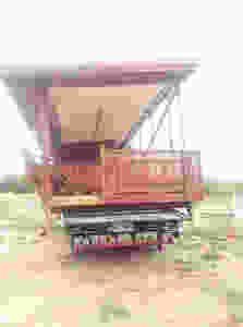 Traditional wooden thai house arriving on site on the back of a truck