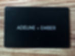 Black business card with white text: ADELINE + EMBER Metal Business Cards.