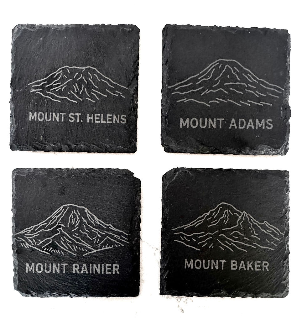 Thumbnail: Four slate coasters with etched mountain peaks reading Mount St. Helens, Adams, Rainier, Baker.
