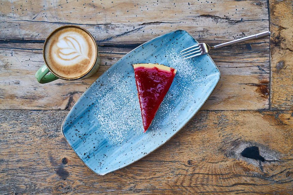 Latte coffee and cheesecake on a table
