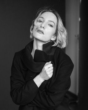 Woman wearing black coat looking at the camera; EDITORIAL PORTRAIT; Jenia Ria.