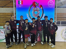 Quintana Roo wrestlers celebrating on the podium with their medals and state uniform after the 2026 Mexican Open Wrestling Championship.