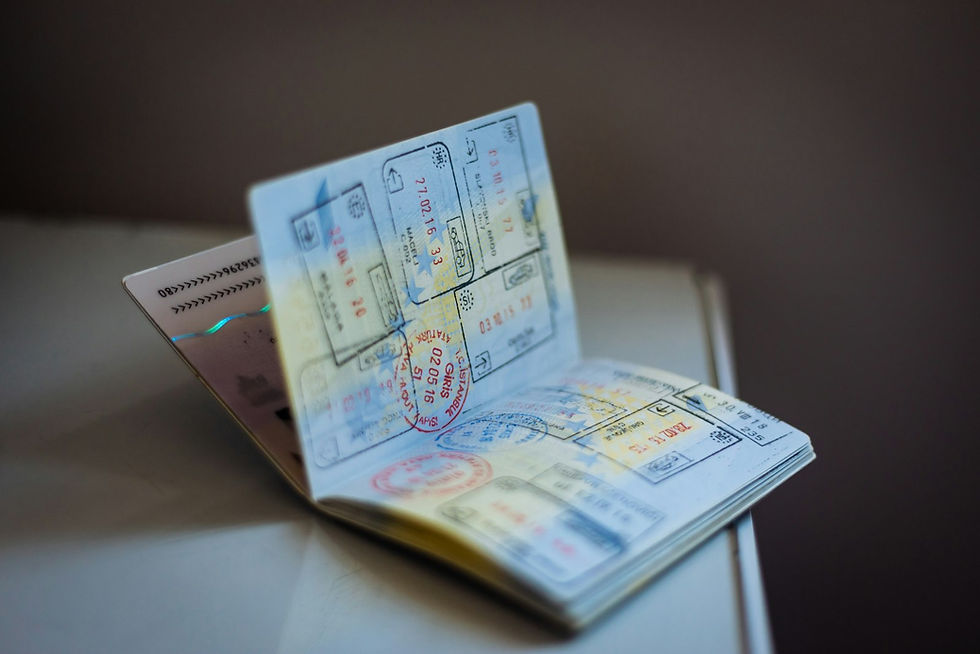 An open passport filled with immigration stamps on a table, representing documentation for a medical trip to Korea