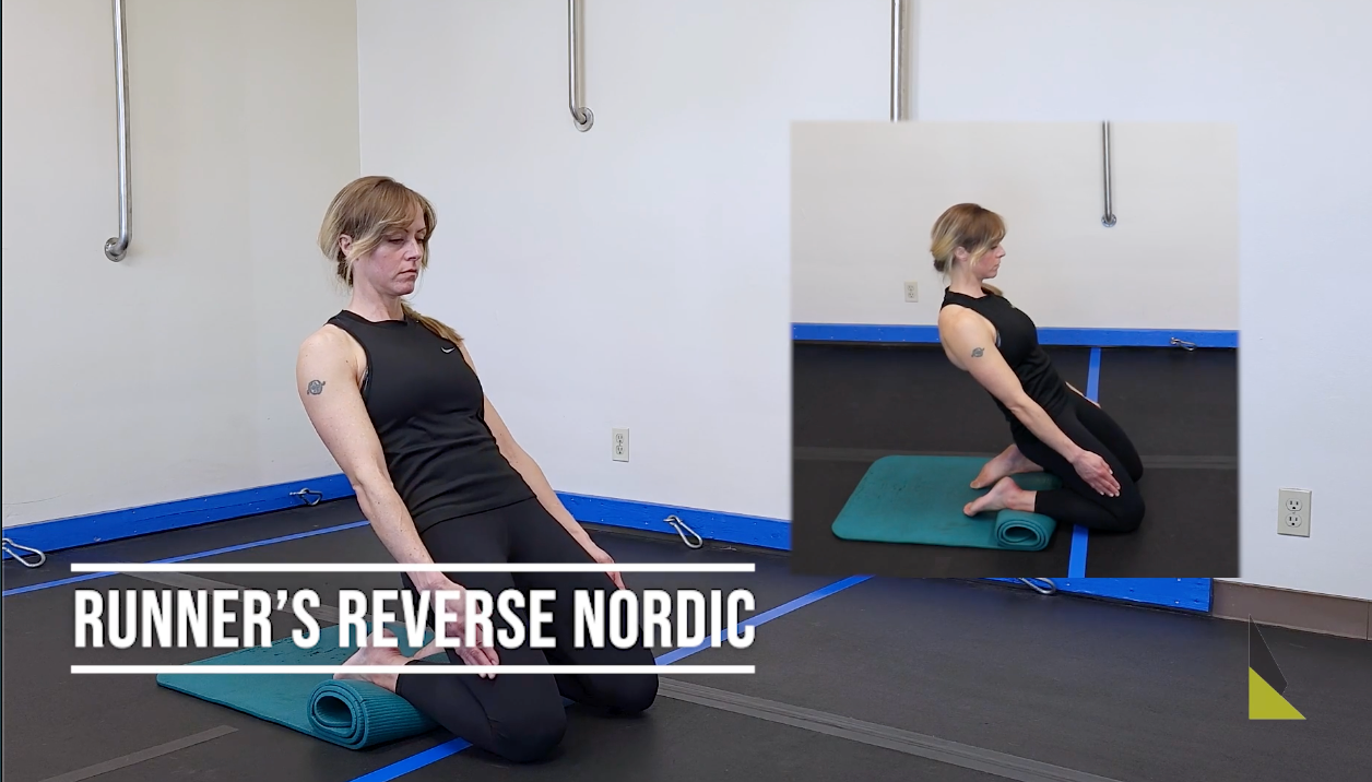 Athlete performing a Reverse Nordic exercise from a kneeling position, leaning backward to eccentrically load the quadriceps muscle group.
