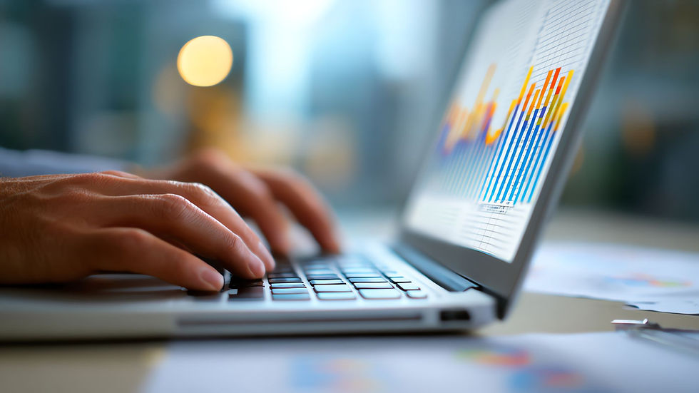 a man working on outcome reporting data on a laptop at an office in Charlotte NC.jpg