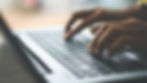 closeup photo of fingers typing on a computer keyboard.jpg