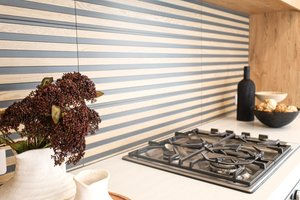 Modern timber pannelling tile splashback with gas hob.