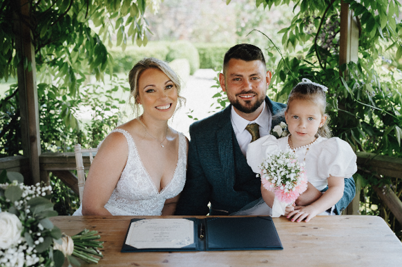 bride, groom and flower girl