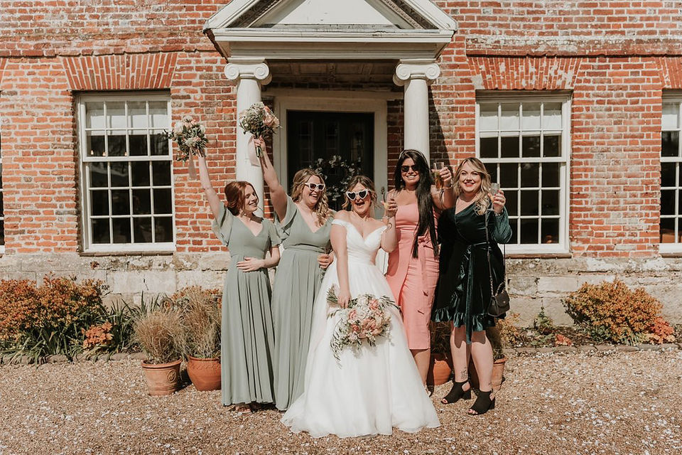 Bride outside her wedding venue with her bridal party