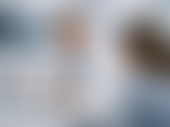 Doctor in white coat discussing breast augmentation with patient, gesturing at healing timeline on a tablet. X-ray images on wall.