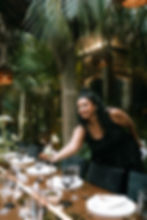 Wedding planner adjusting table details during an outdoor destination wedding reception