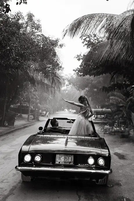 Bride and groom driving away after destination wedding in Tulum