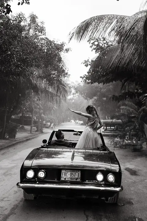 Bride and groom driving away after destination wedding in Tulum