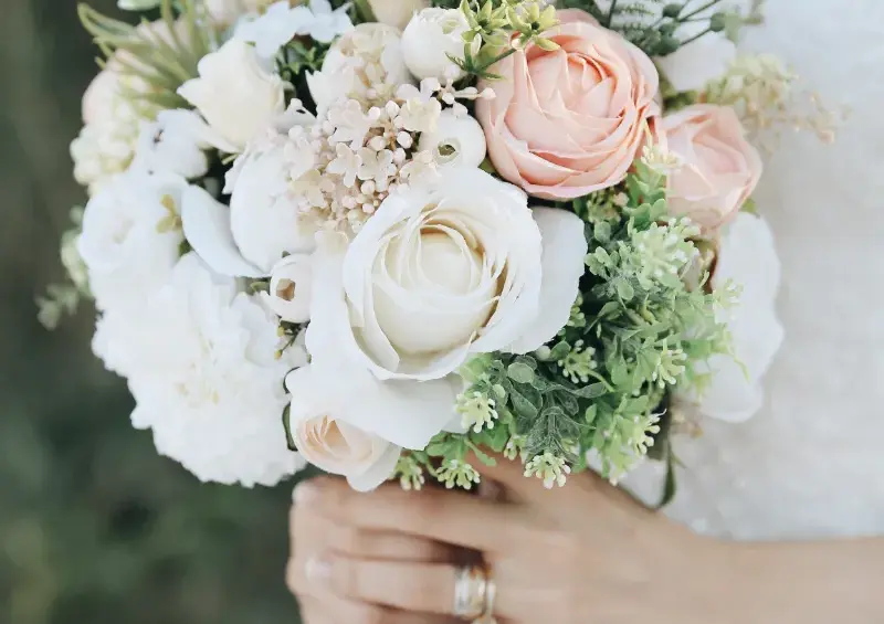 White wedding reception table with candles and floral centerpieces in Riviera Maya.