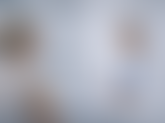 A doctor discusses a clipboard with a patient in a bright office. Certificates are displayed on the wall. The mood is professional and calm.