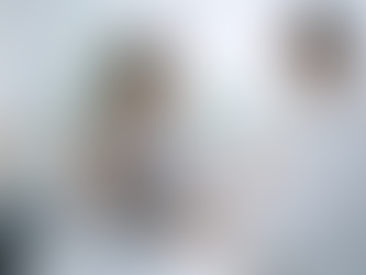 Doctor and patient in a light room, discussing a clipboard. Tropical plants in background. Passport, water, and travel items nearby.