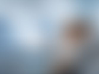 Two people sit in a modern room, focused on a screen displaying digital DNA and a human profile. The mood is analytical and curious.