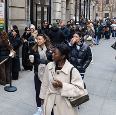 Attendees waiting in line for Pomexpo Norooz Bazaar on a busy New York City street